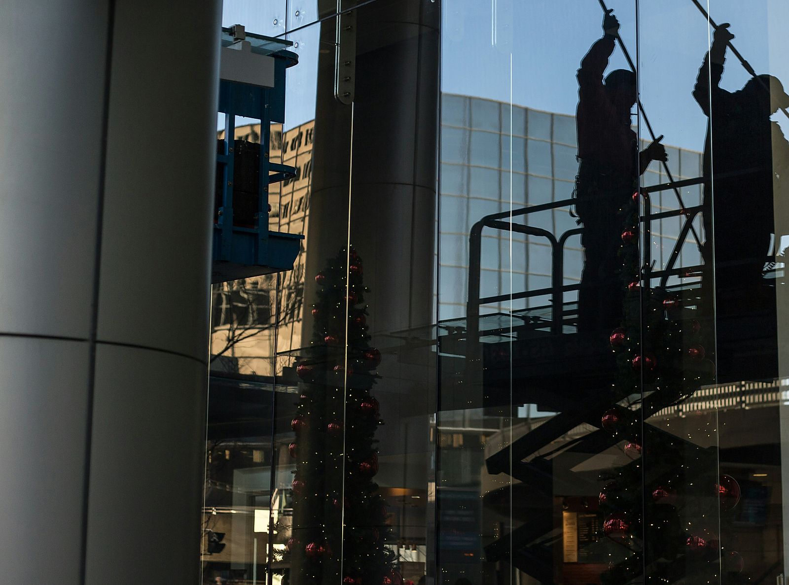 Cleaned glazing reflecting a blue sky and buildings